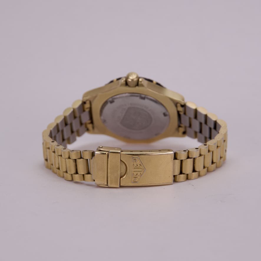 Gold wristwatch with metal link bracelet.