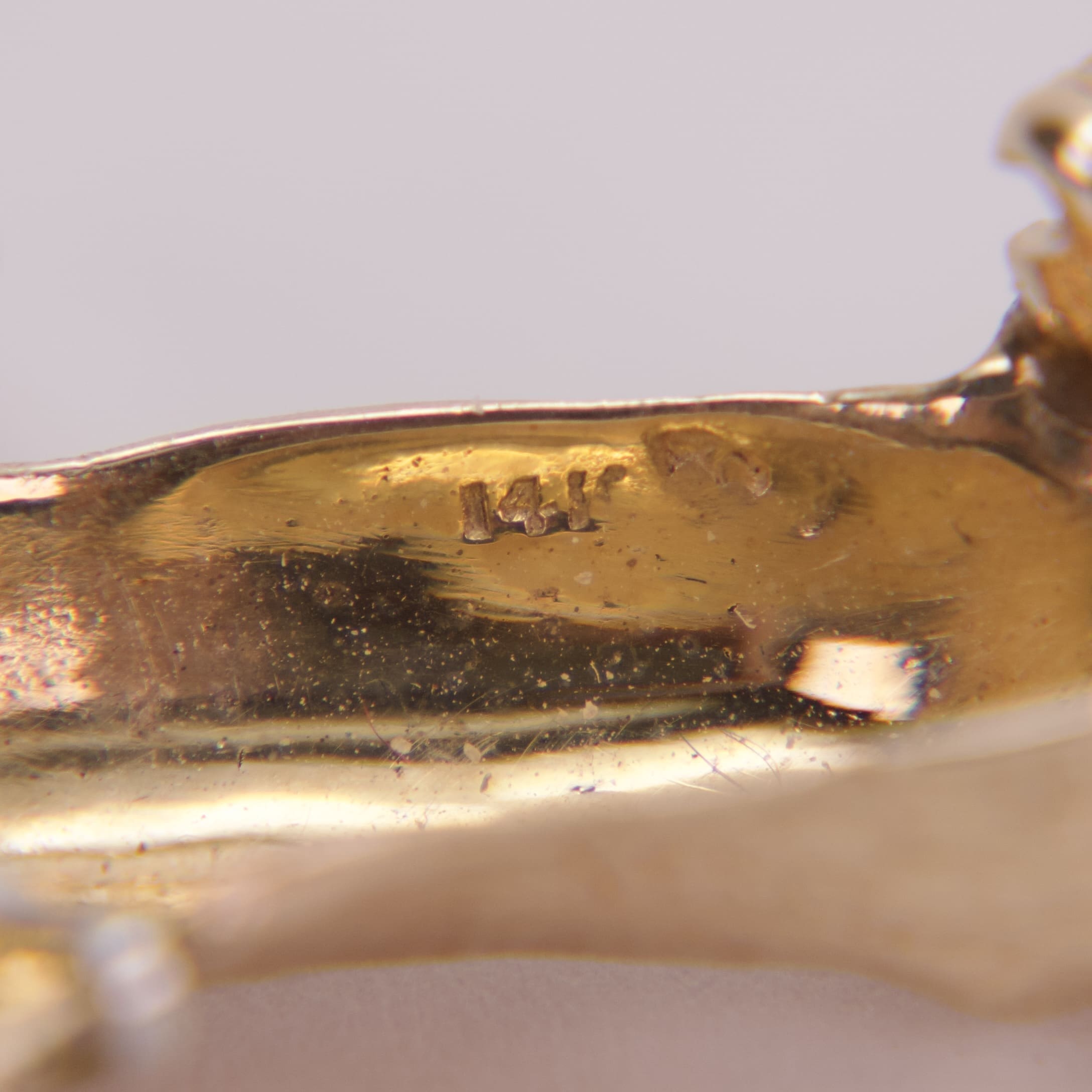 Gold jewelry with "14K" engraved marking.