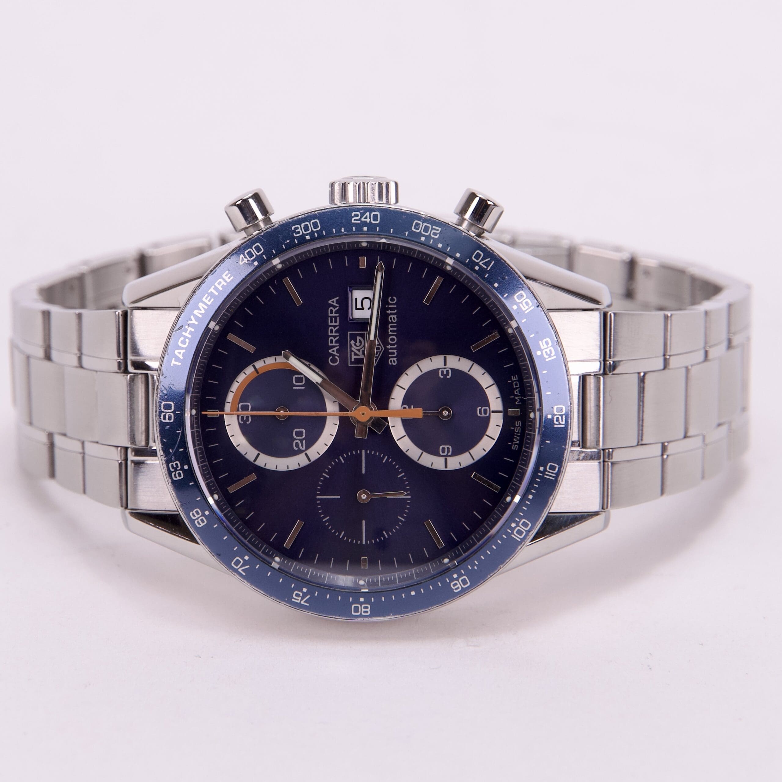 Luxury silver watch with blue dial.