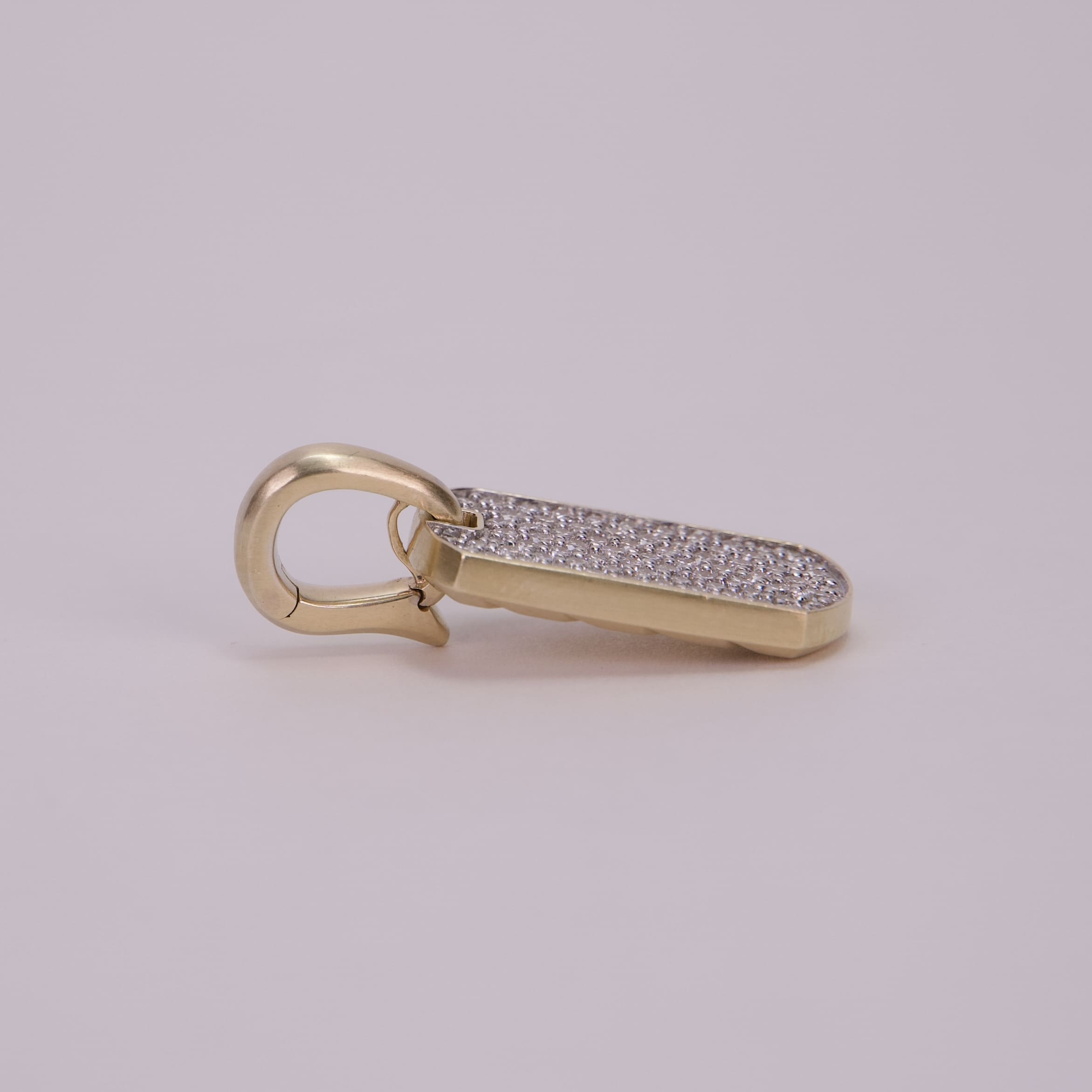 Gold and diamond-studded pendant on display.