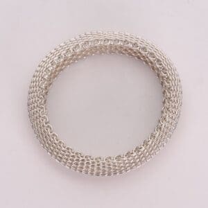 Silver chainmail bracelet on white background.