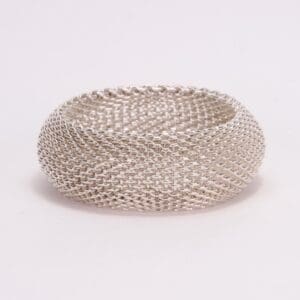 Silver mesh bracelet on white background.