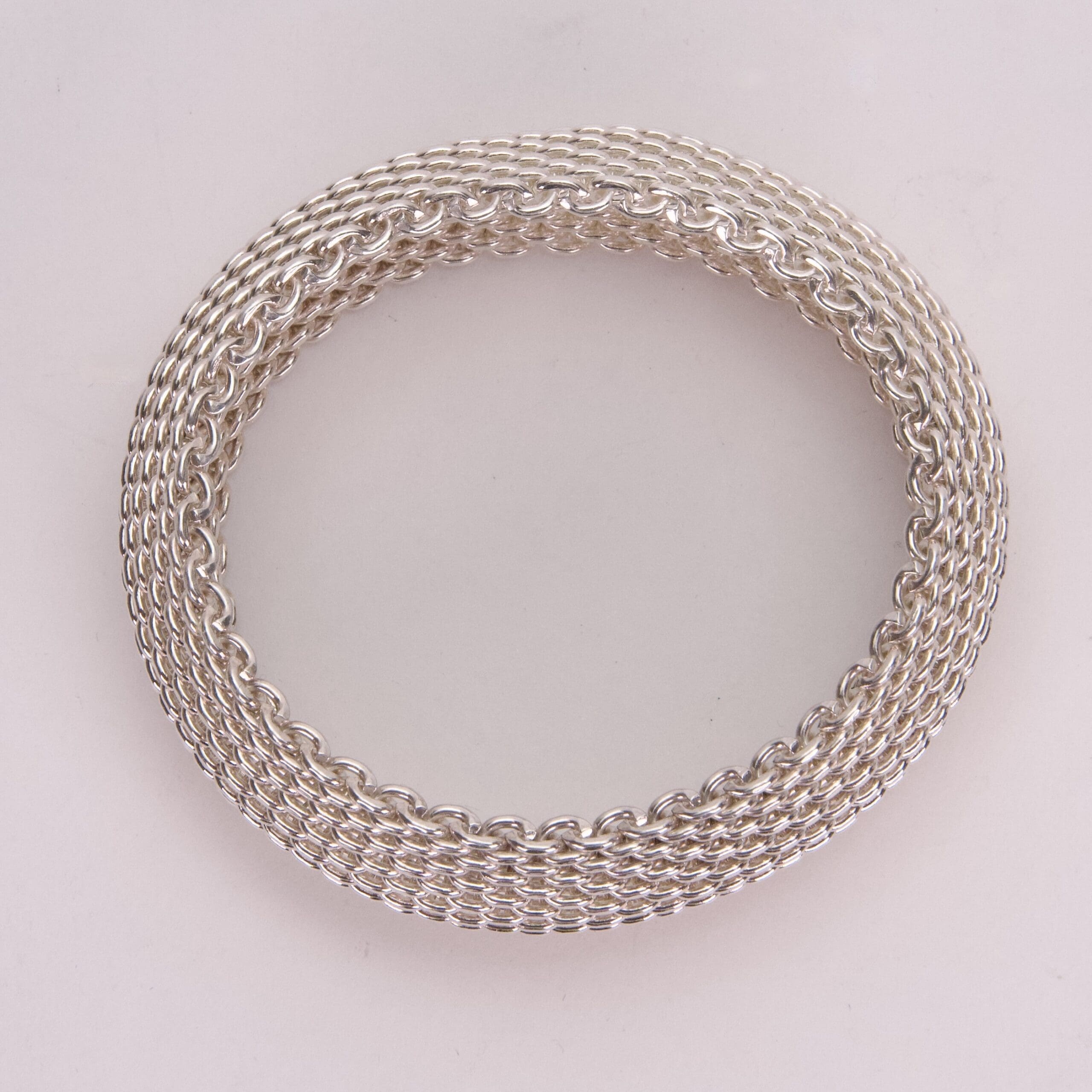 Silver woven chain bracelet on display.