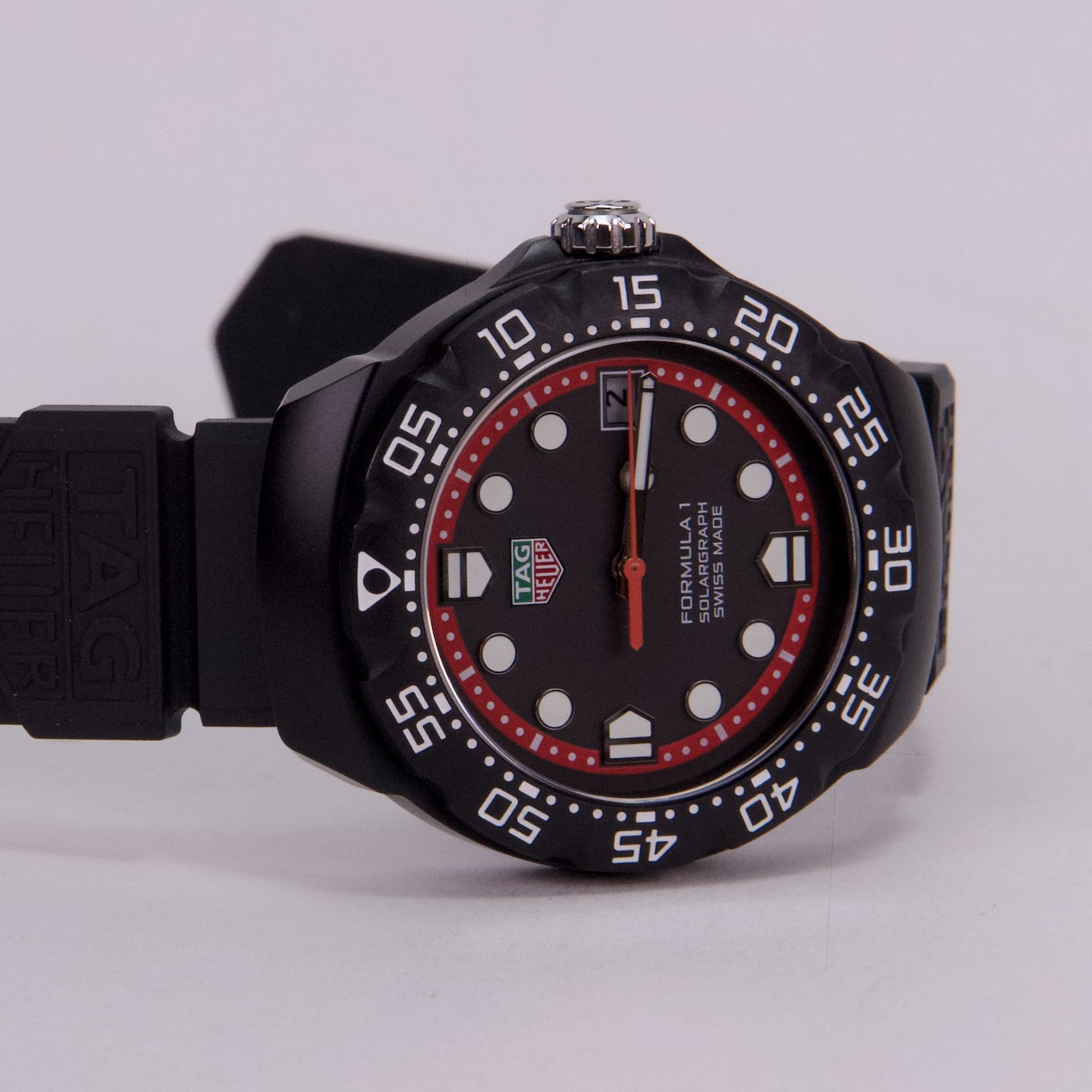 Black sports watch with red accents.