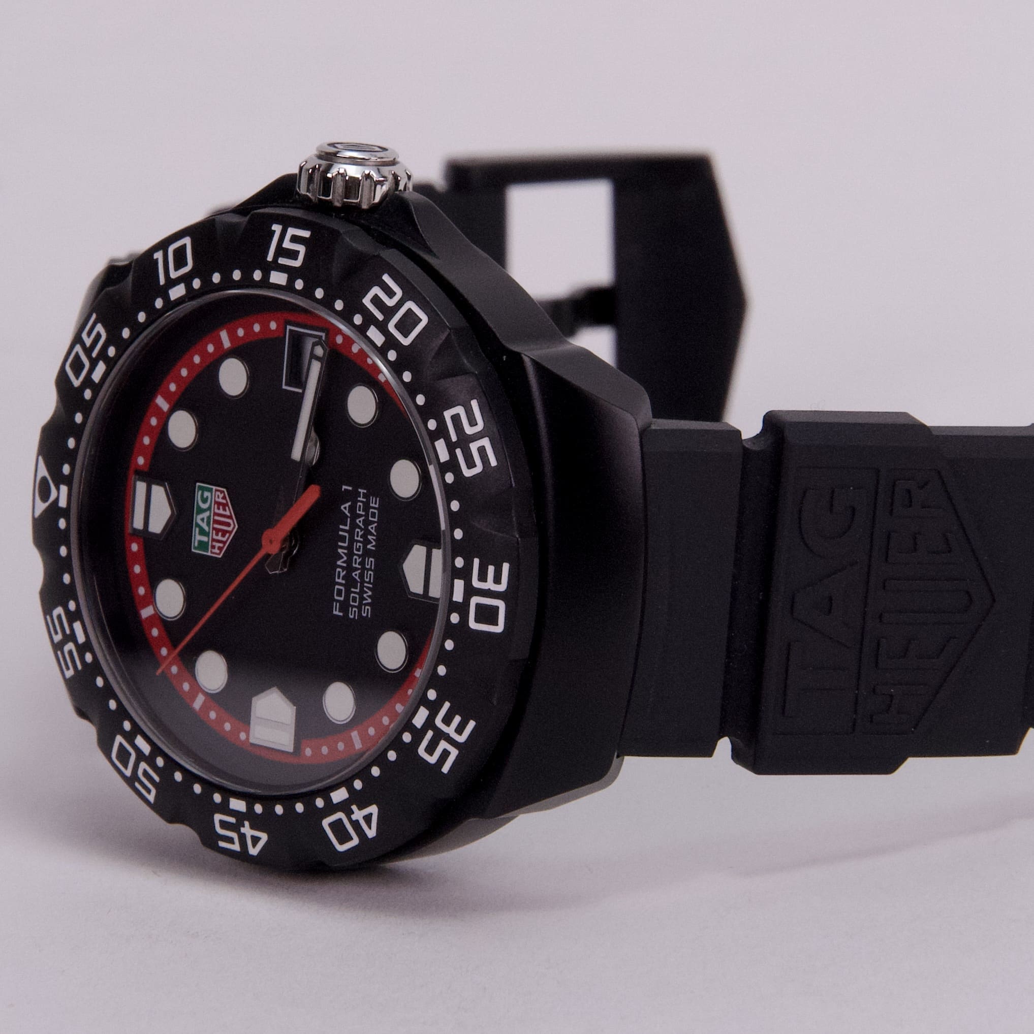 Black sports watch with red accents.