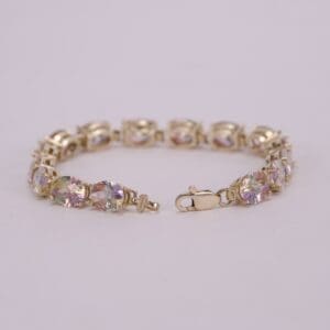Gold bracelet with colorful gemstone accents.