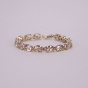 Gold bracelet with multicolored gemstones.