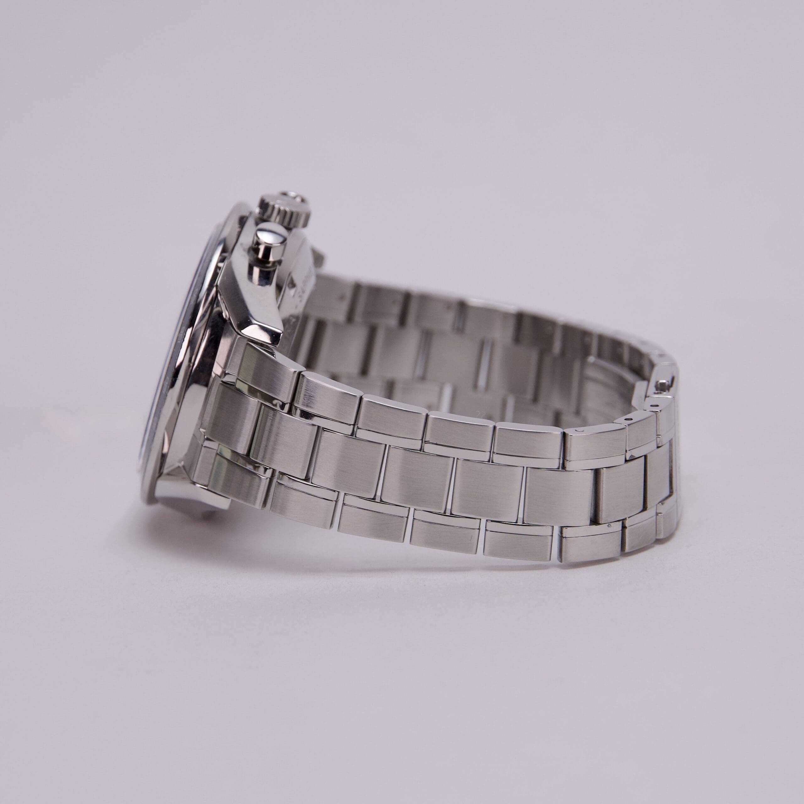 Silver metal watch with linked bracelet.