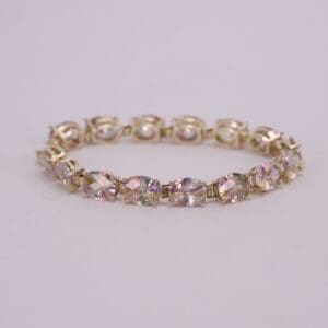 Gold bracelet with colorful gemstone accents.