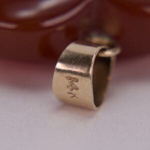 Close-up of 14K gold jewelry stamp.