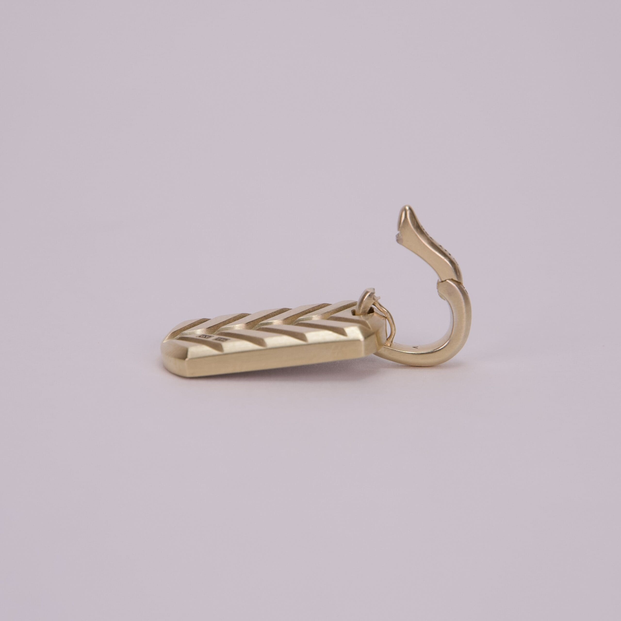 Gold hook with a textured design.