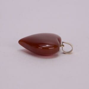Red teardrop-shaped pendant with metal loop.