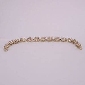 Gold bracelet with clear gemstone accents.