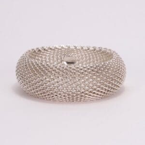 Silver mesh bracelet on white background.