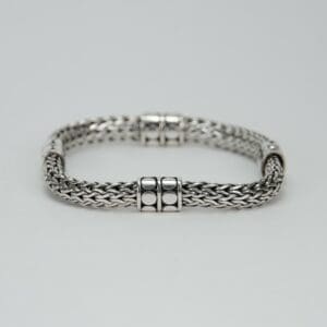 Silver woven bracelet with clasp details.