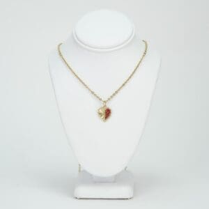 Gold necklace with a heart pendant.