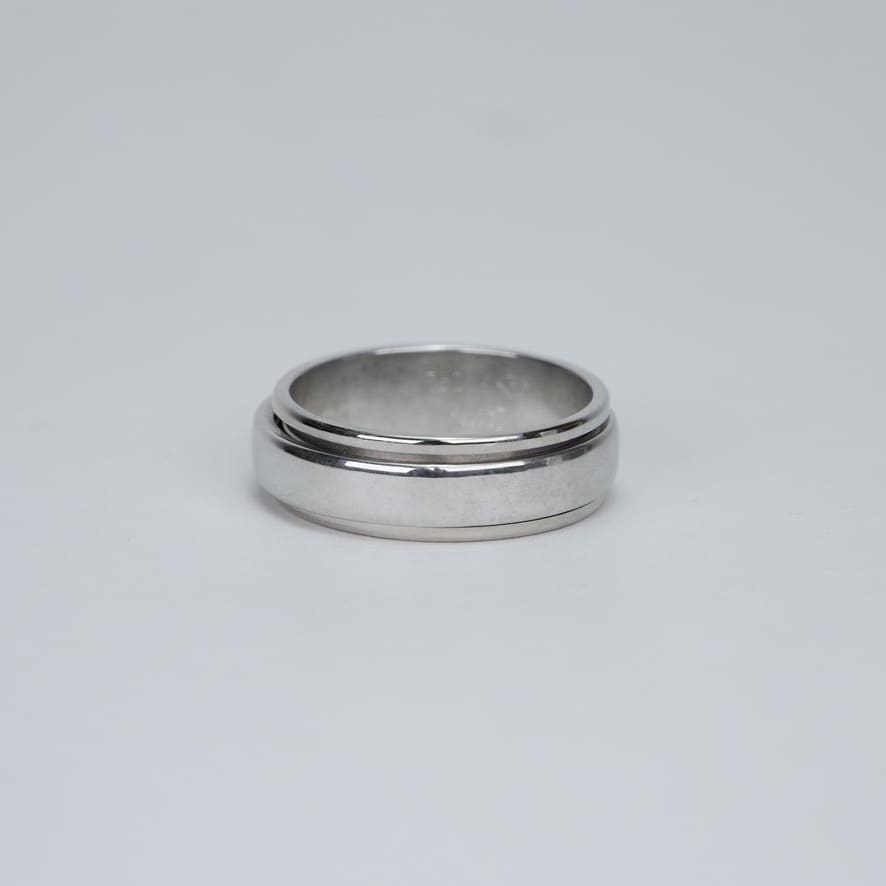 Silver ring on a plain background.