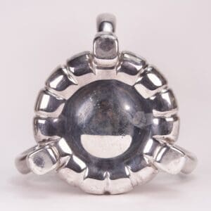 Silver ring with a circular, textured design.