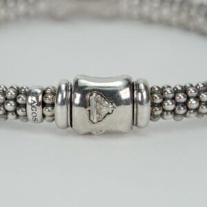 Silver beaded bracelet with intricate clasp.