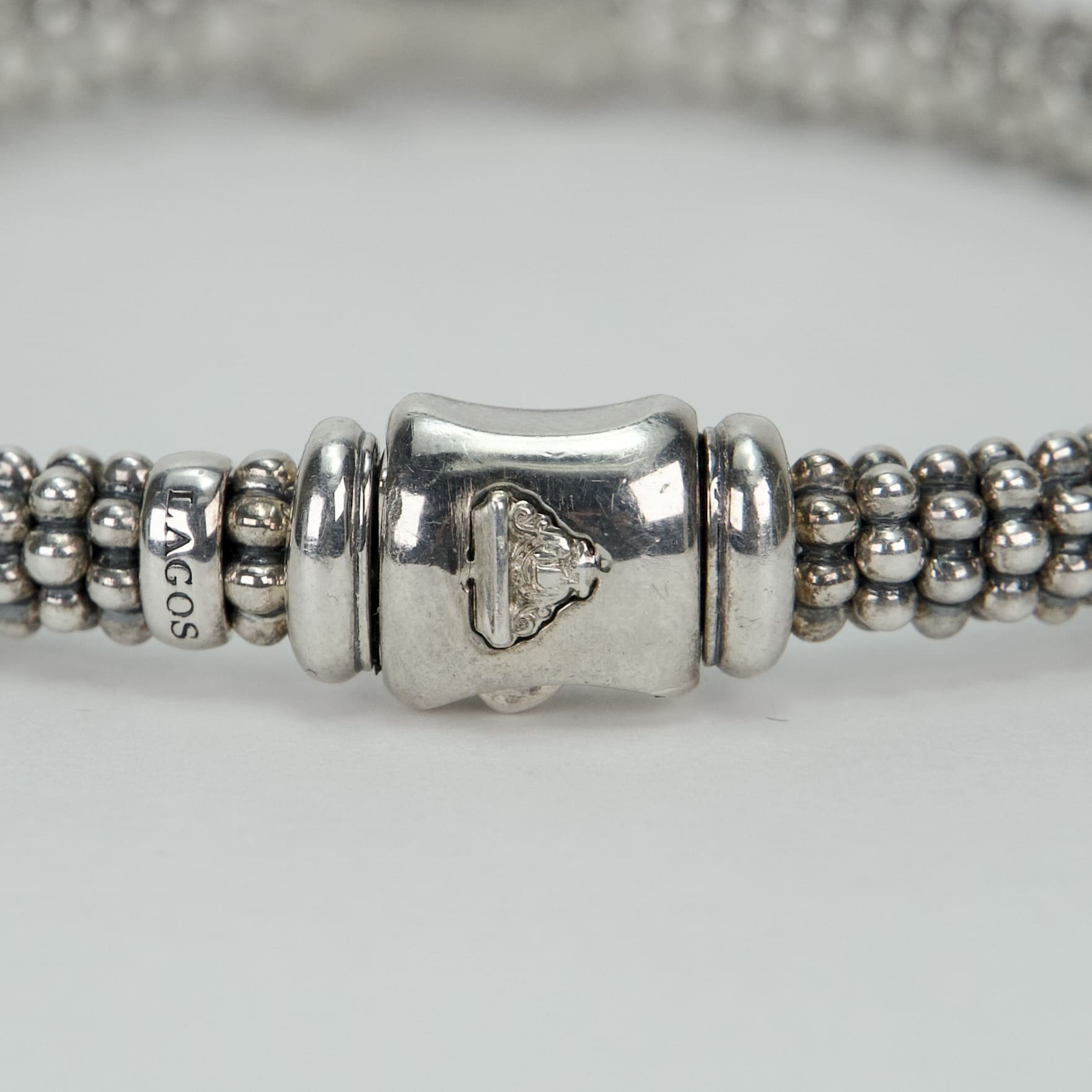Silver beaded bracelet with intricate clasp.