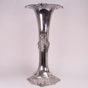 Ornate silver vase with floral details.