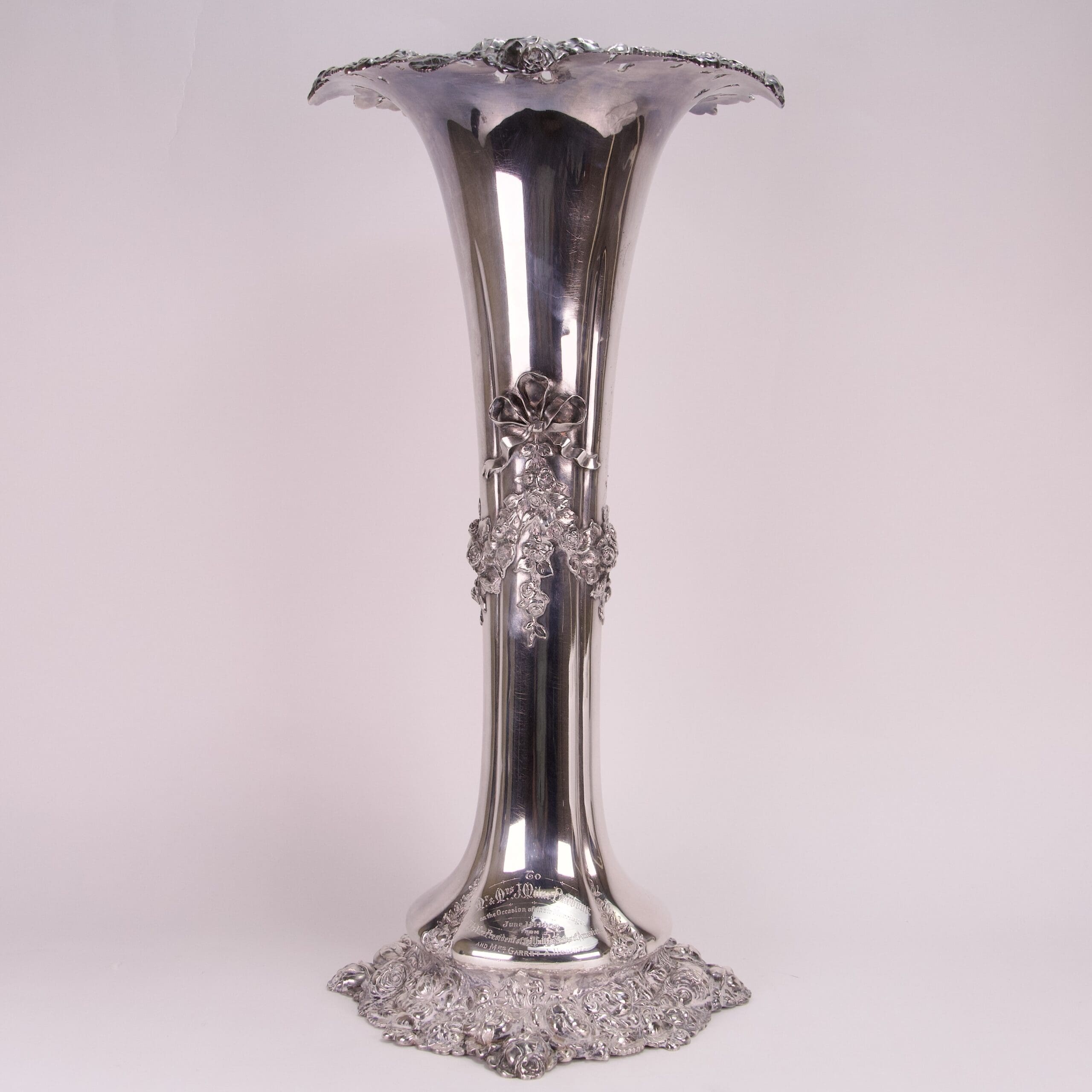 Ornate silver vase with floral details.