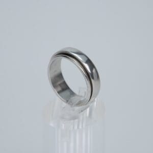 Silver ring on clear display stand.