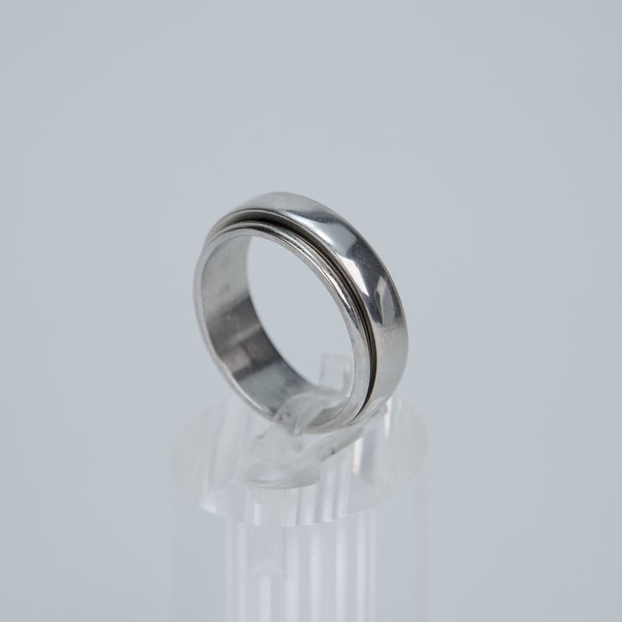 Silver ring on clear display stand.