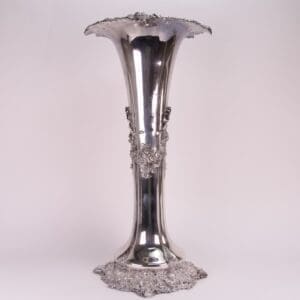 Ornate silver vase with decorative detailing.