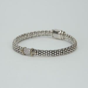 Silver beaded bracelet with decorative clasp.