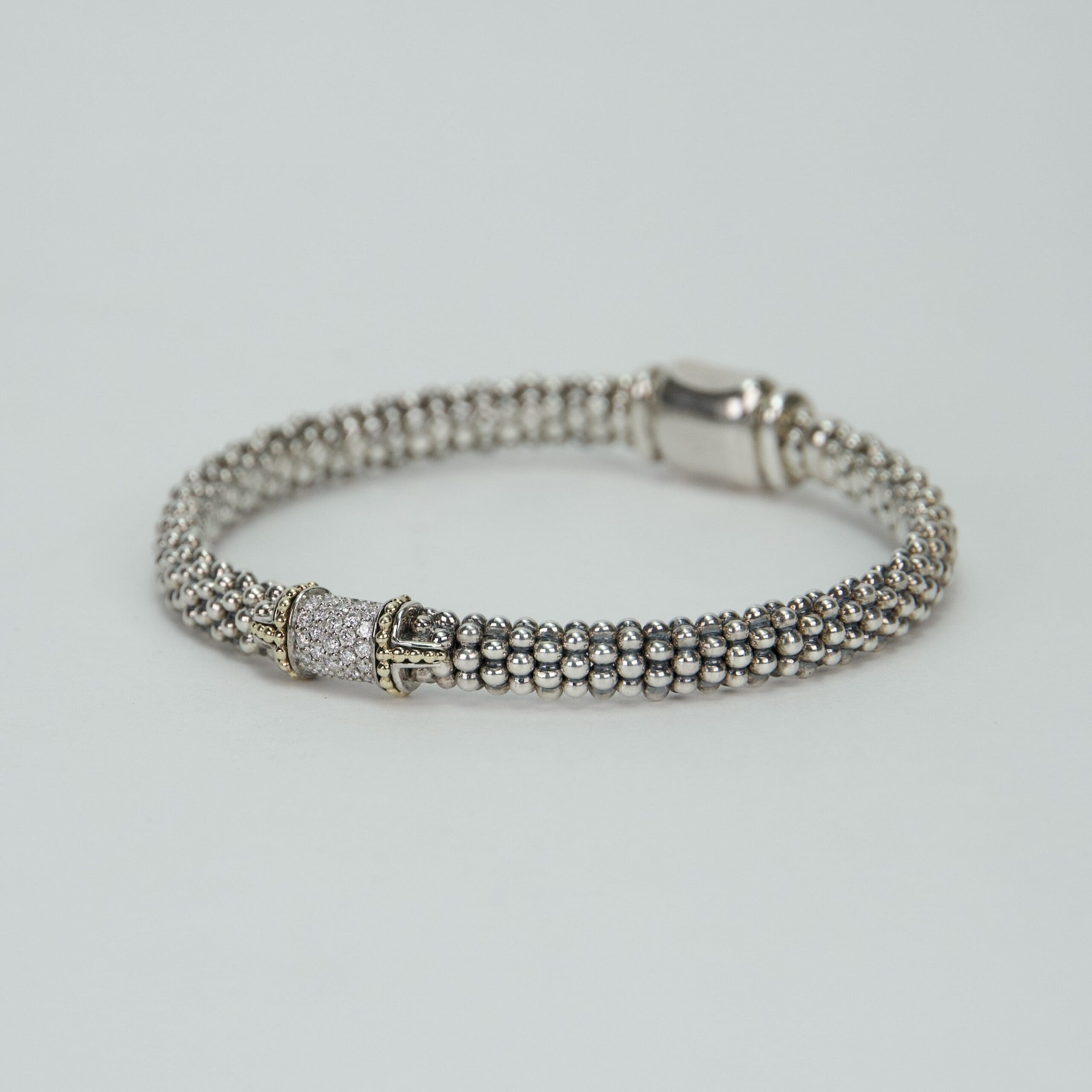 Silver beaded bracelet with decorative clasp.