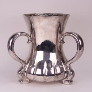 Silver vase with ornate curved handles.
