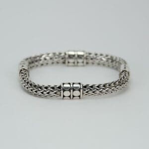 Silver braided bracelet with decorative clasps.