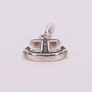 Anchor-shaped pendant with black gemstone accents.