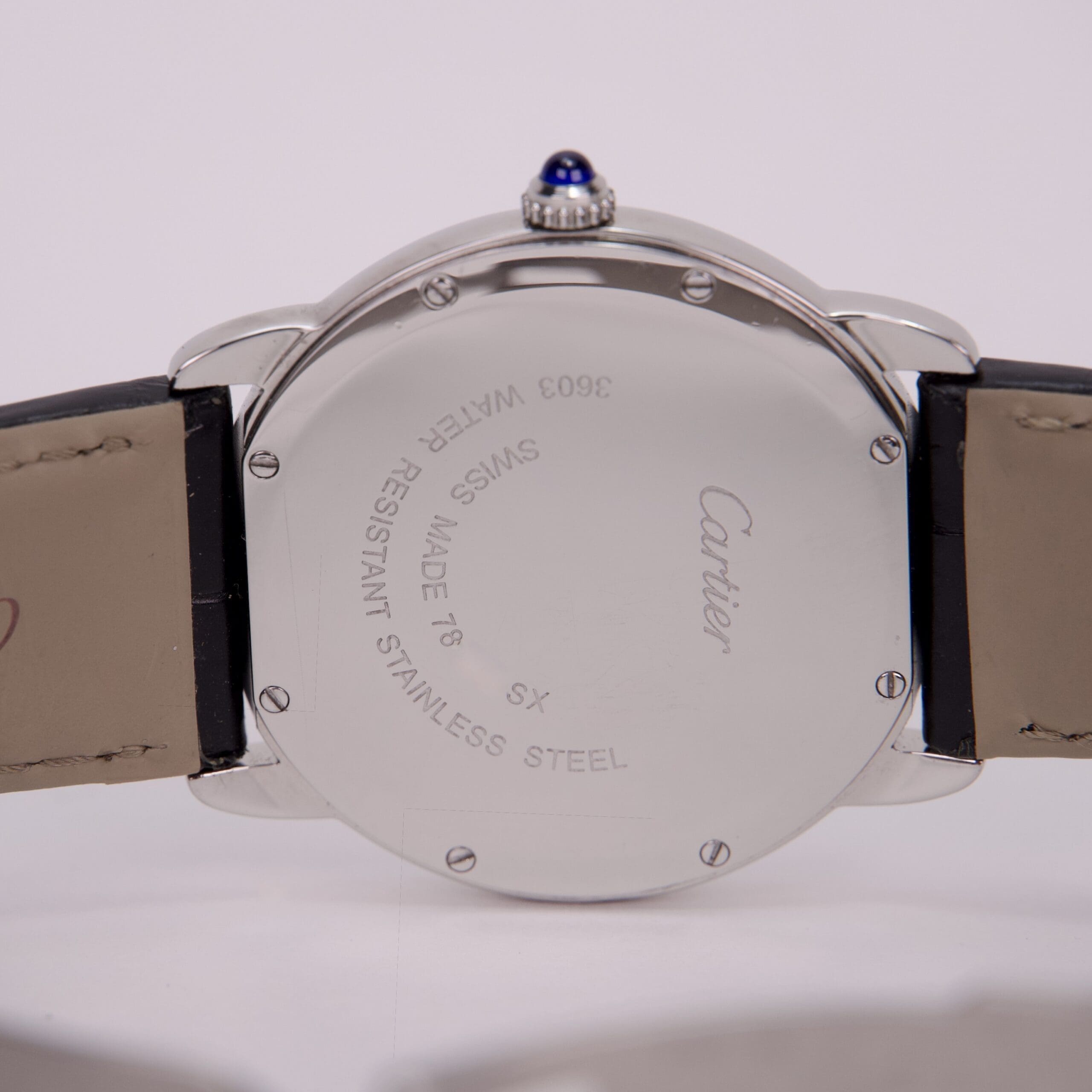 Back of a Cartier wristwatch with leather strap.