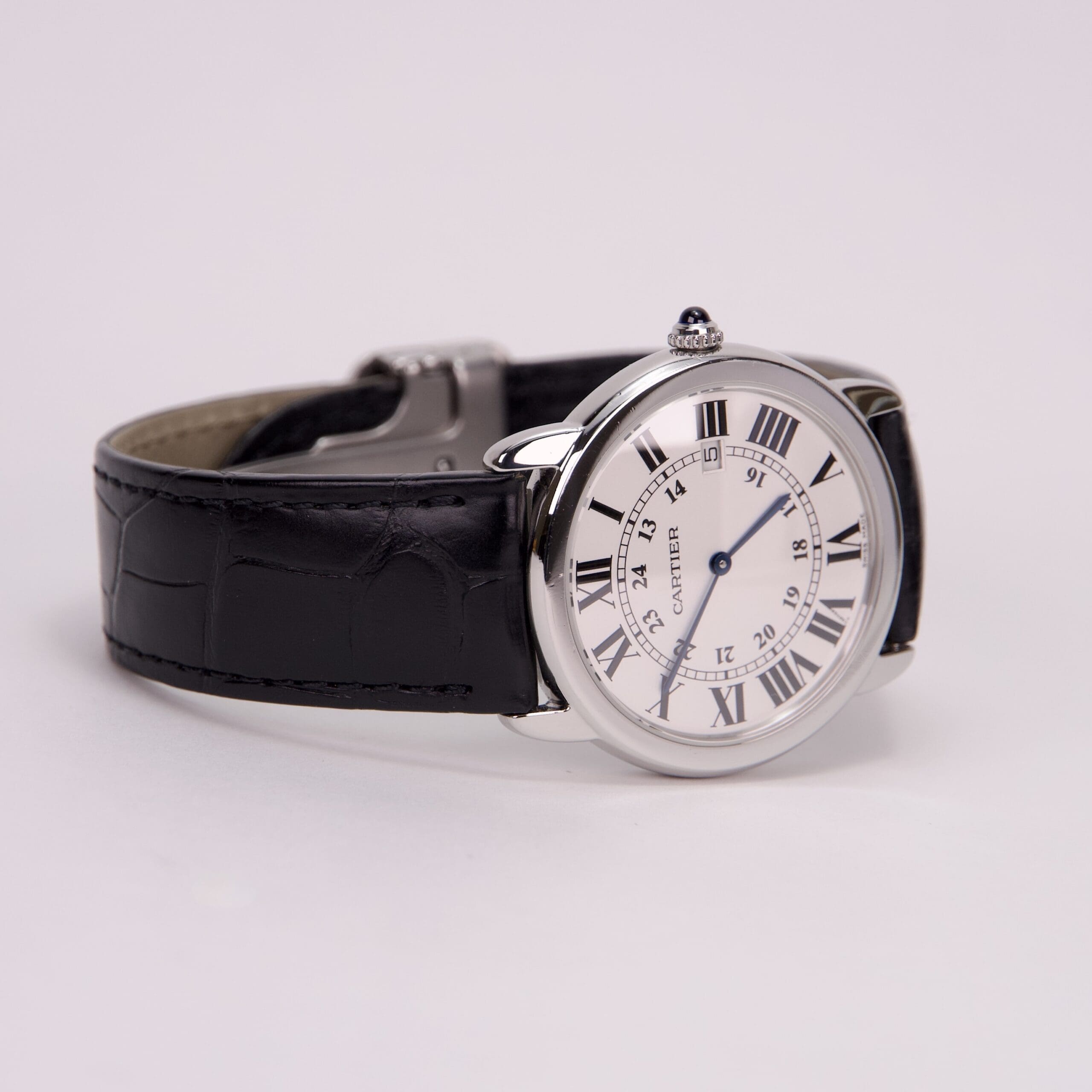 Silver watch with black leather strap.