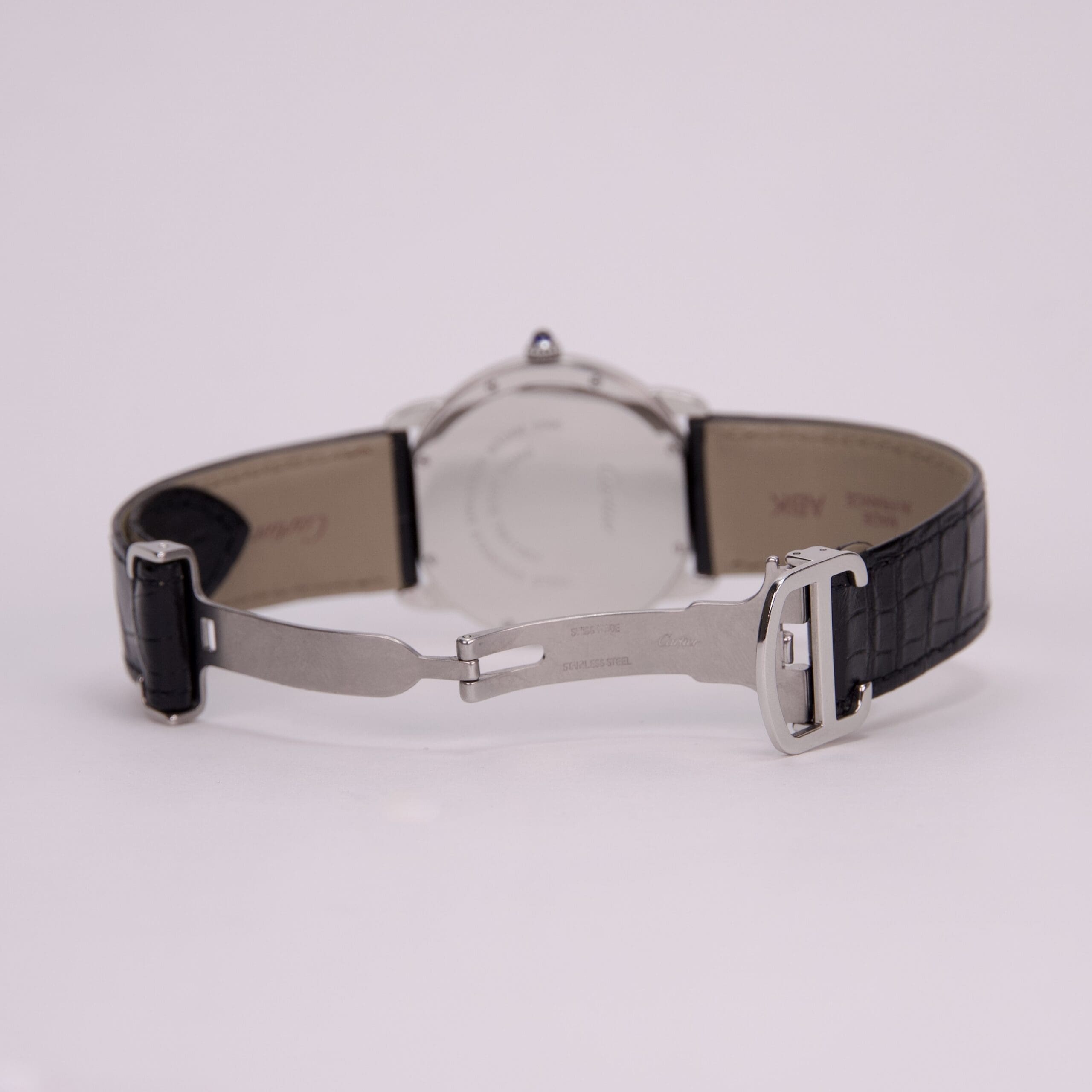Watch with black leather strap and clasp.