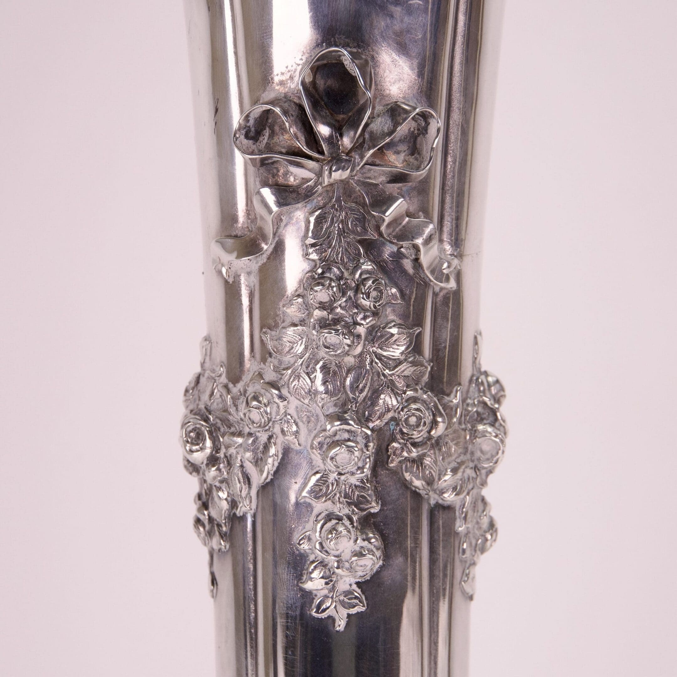 Ornate silver vase with floral details.