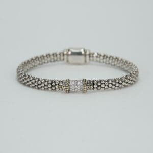 Silver beaded bracelet with decorative clasp.