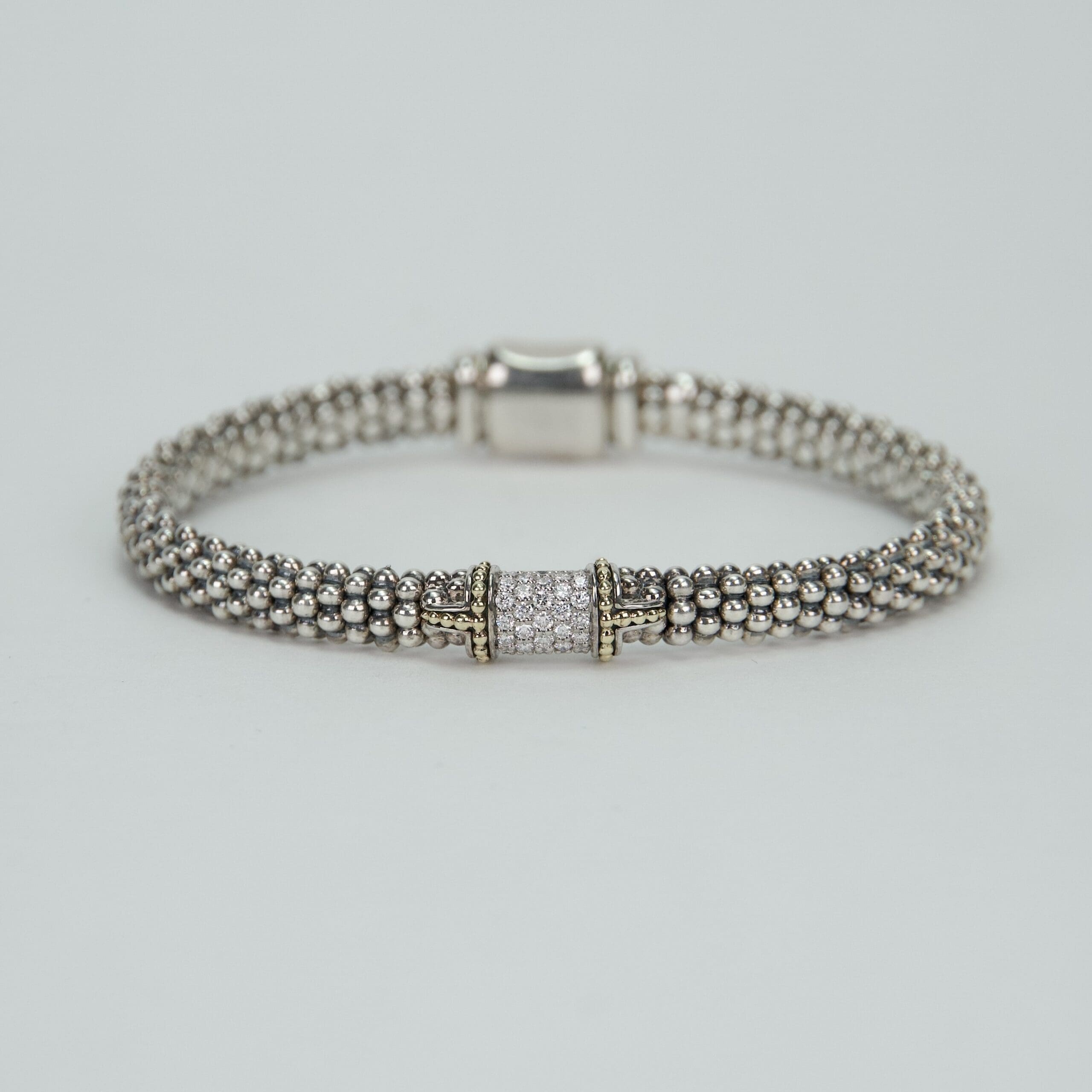 Silver beaded bracelet with decorative clasp.