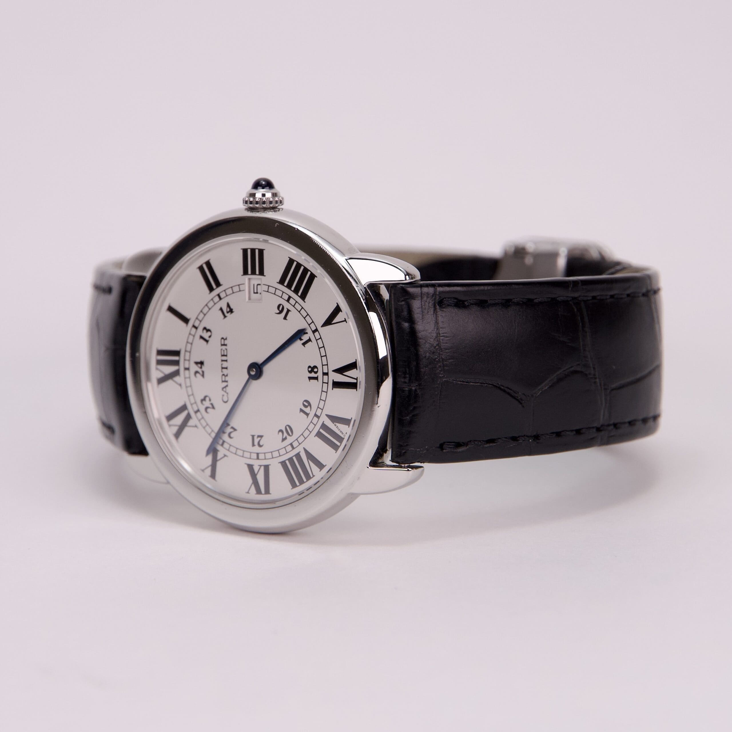 Silver watch with black leather strap.