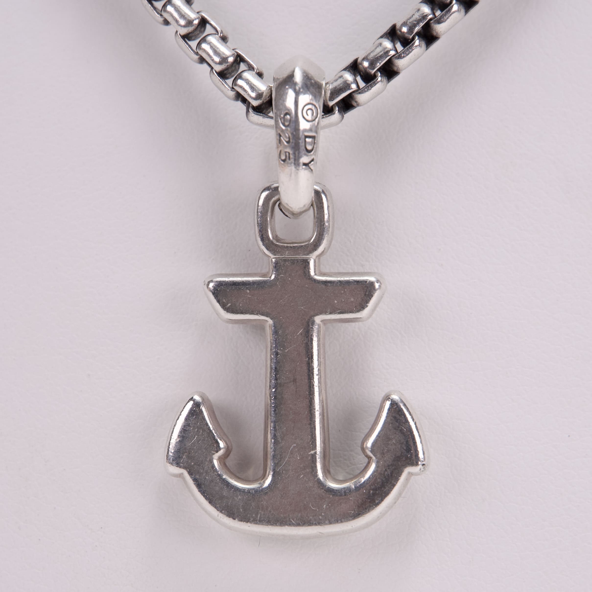 Anchor pendant on a chain necklace.