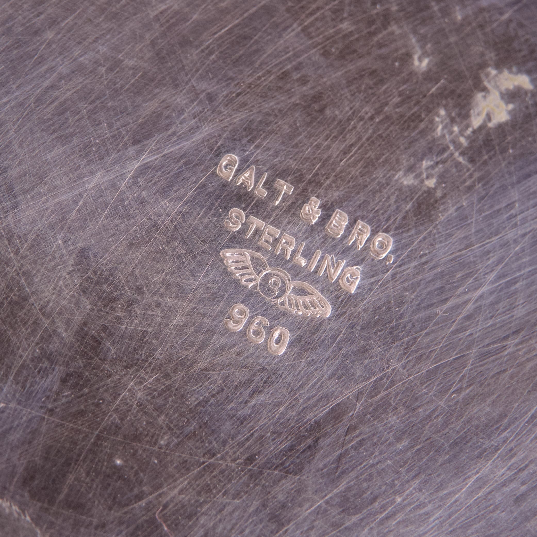 Engraving on scratched metal surface.