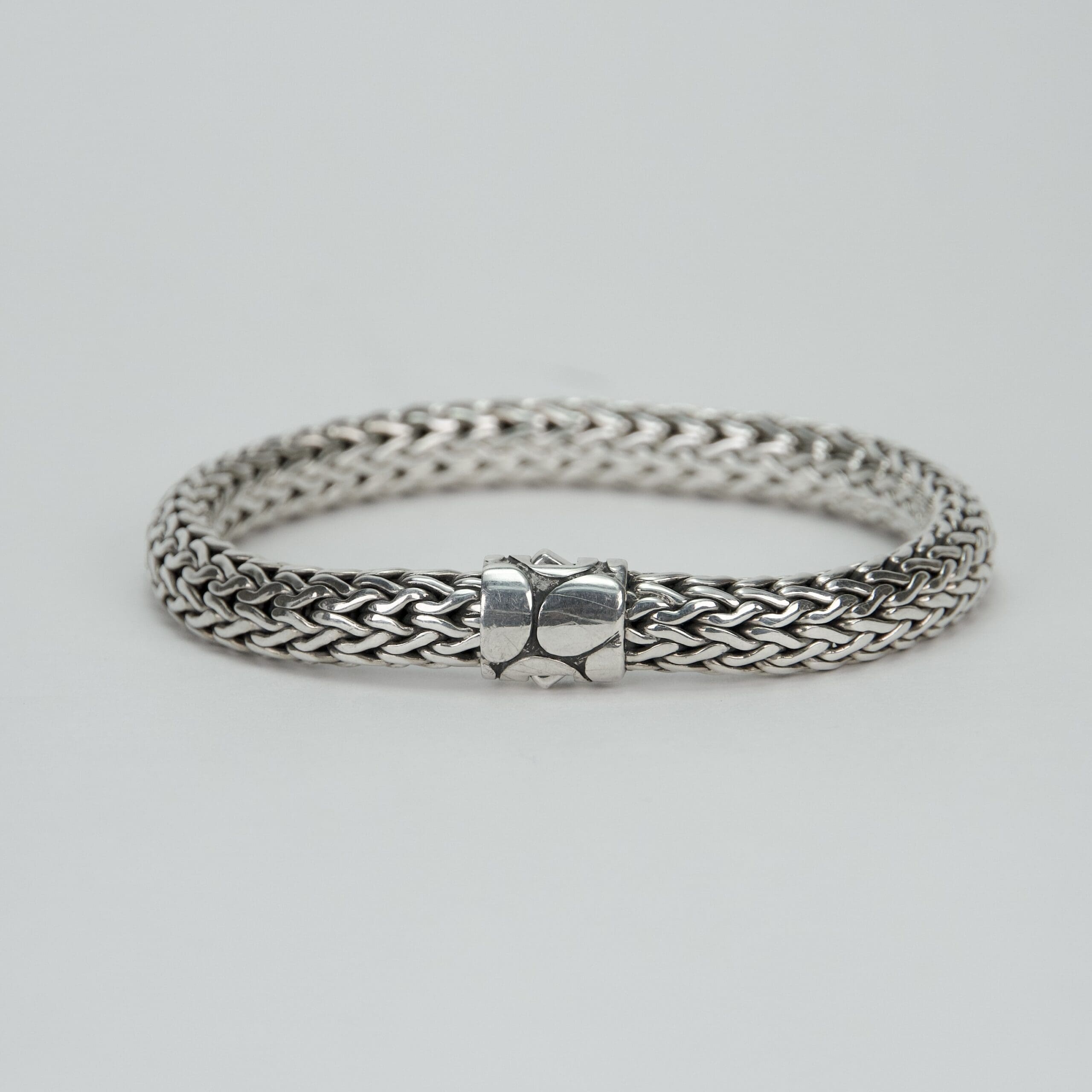 Silver woven bracelet with clasp.