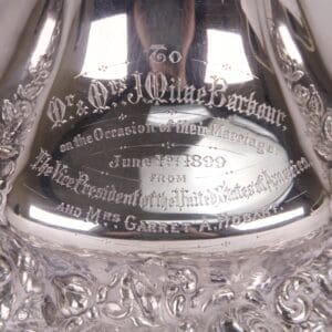 Engraved silver item with intricate detailing.