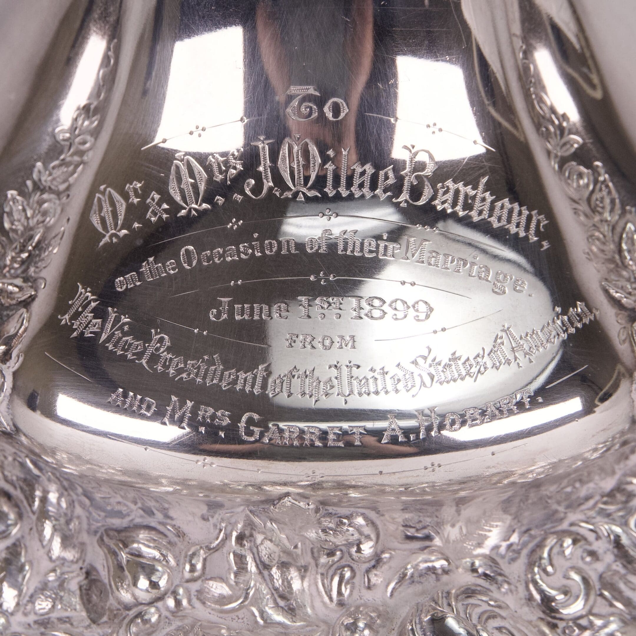 Engraved silver item with intricate detailing.