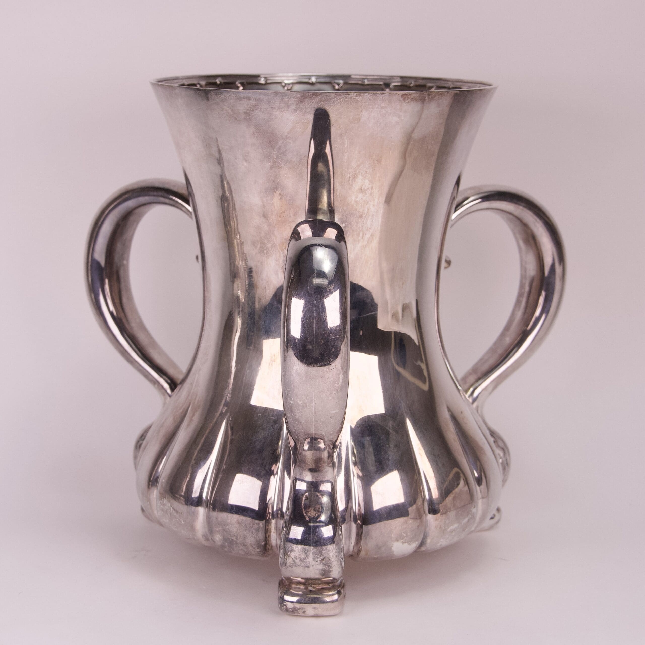 Silver trophy cup with two handles.
