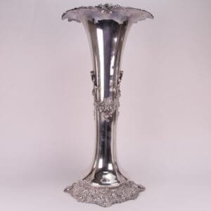 Ornate silver vase with floral patterns.