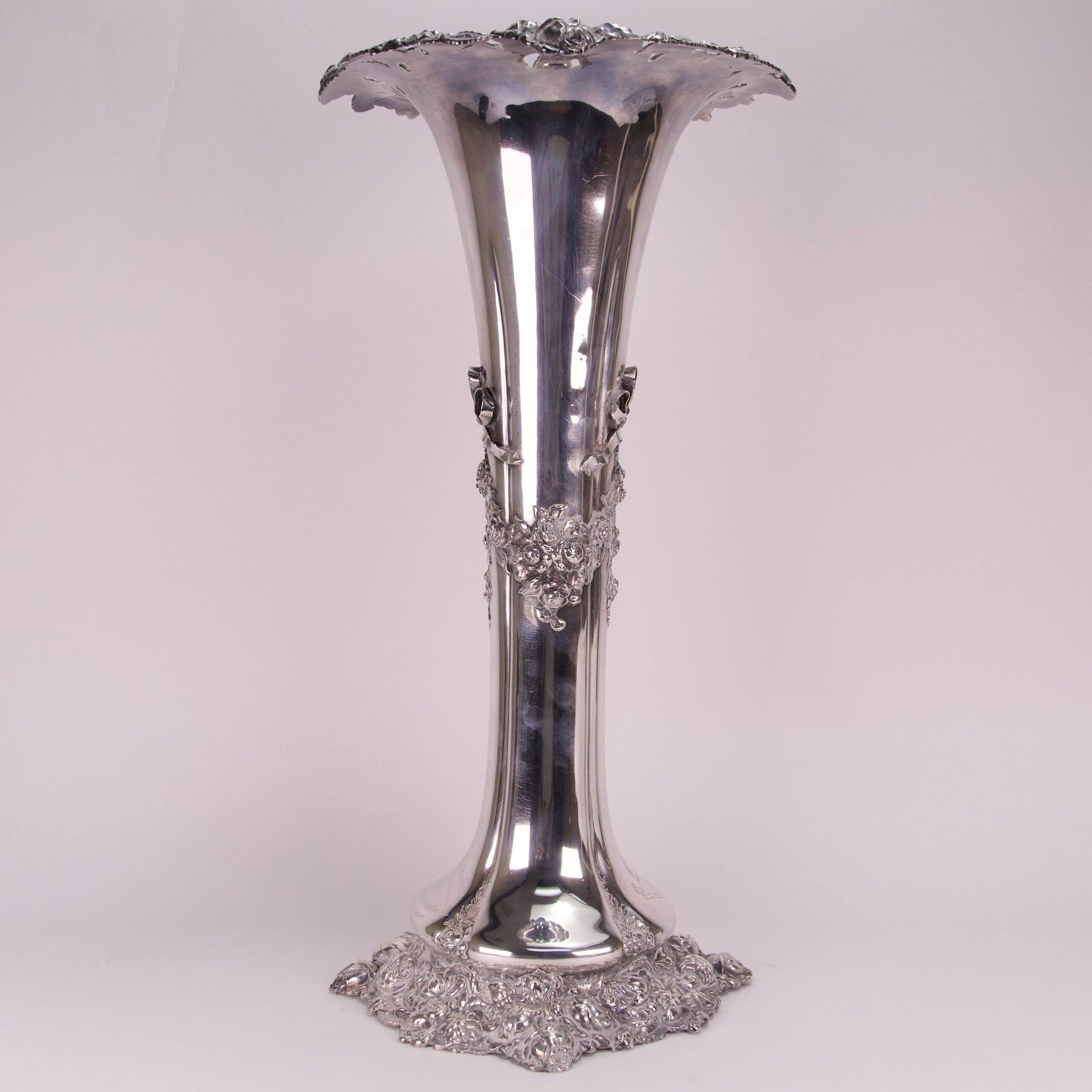 Ornate silver vase with floral patterns.