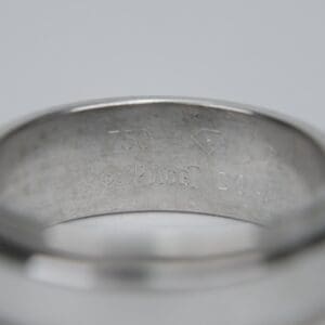 Close-up of silver ring with engravings.